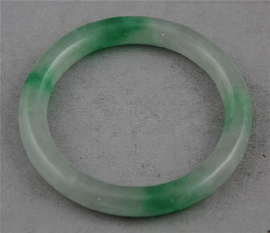 A Chinese ice white and emerald green jadeite bangle, 7.4cm.